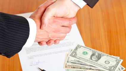Business handshake after signed contract