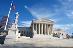 United States Supreme Court Building and American Flag