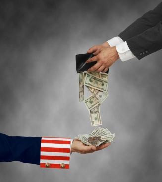 Businessman opening wallet with cash falling out into Uncle Sam’s hand
