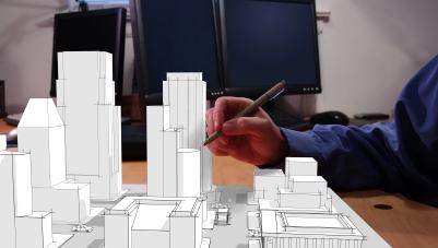 Architect drawing a city in 3d on his desk