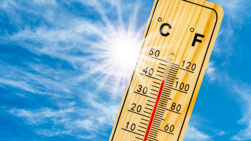 Image of a thermometer in front of a blue sky